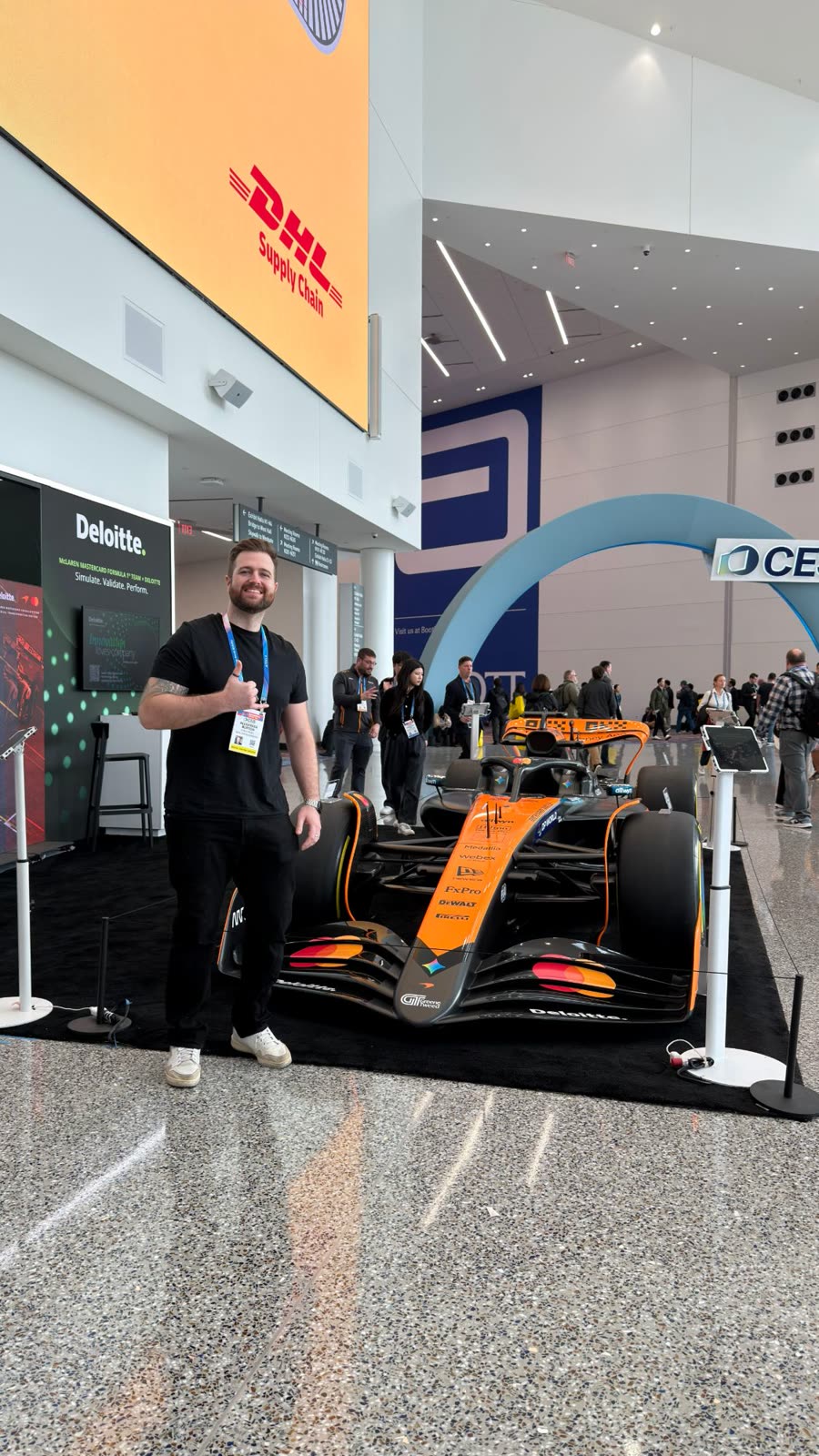 Alex beside the McLaren Formula 1 car at CES